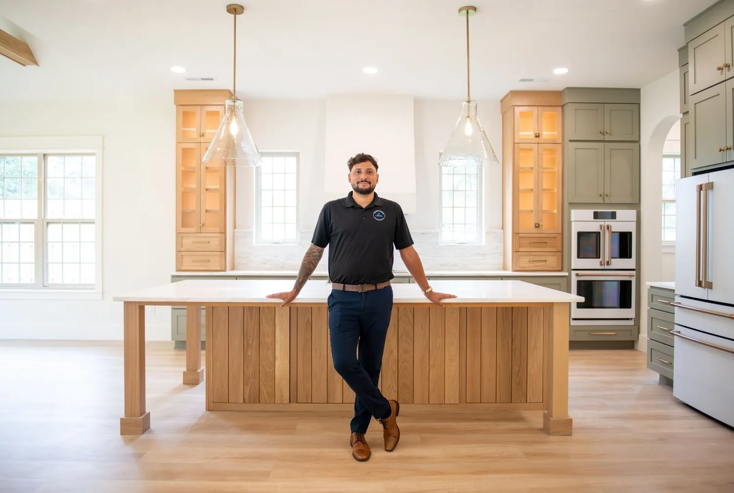 Chris Delaney, owner of Delaney's Coastal Construction, standing in a finished kitchen