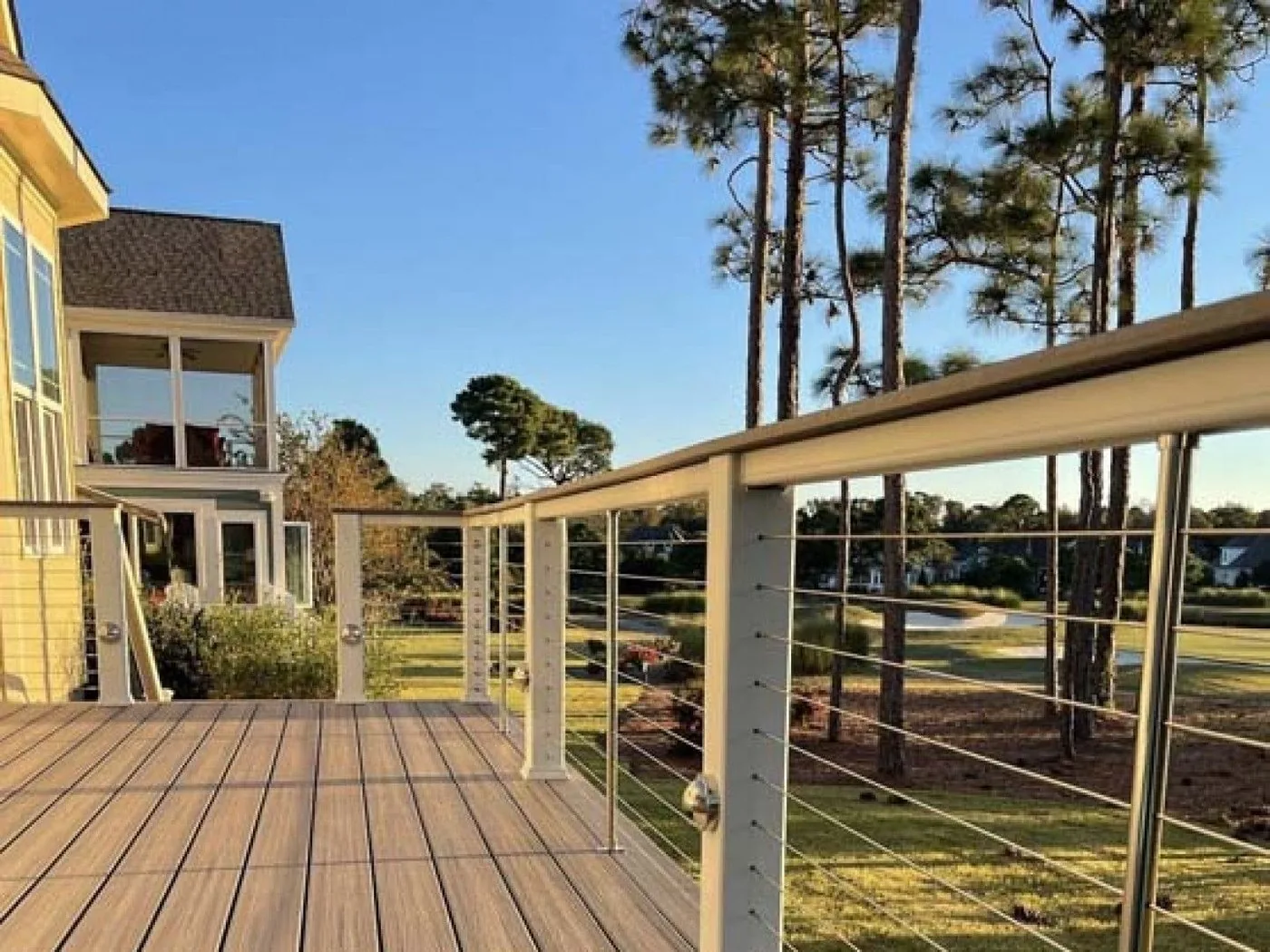 Elevated deck with cable railing overlooking a wooded lot