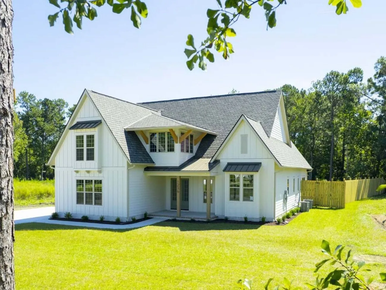 Aerial view of a completed new home with a fenced yard