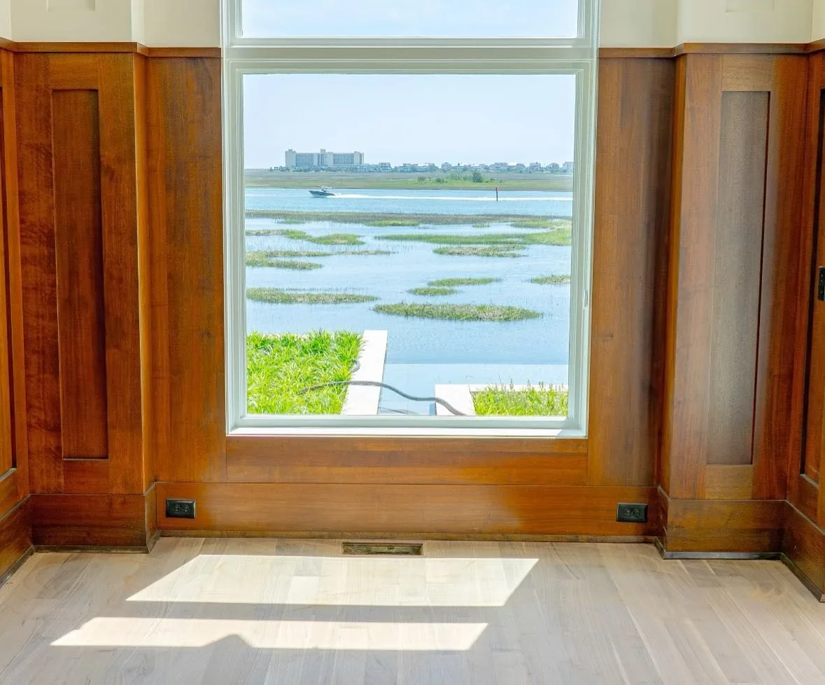 Wood clad window looking out over the marsh